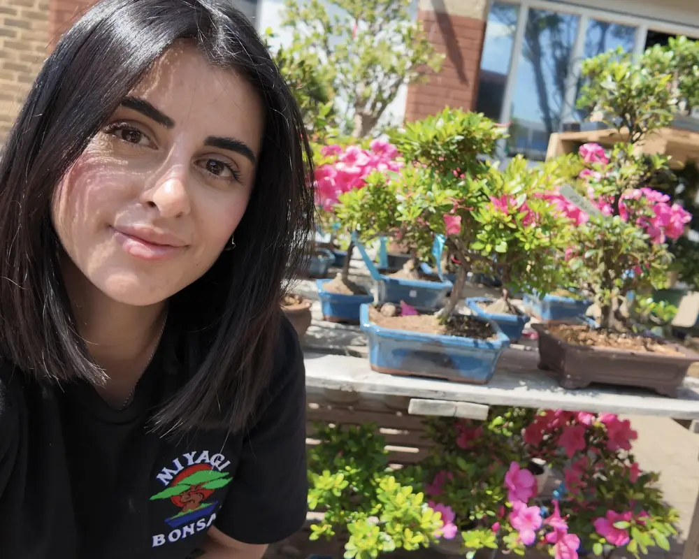 Miriana with a Collection of Bonsai Trees