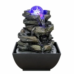 Miniature stone slab waterfall fountain with a glowing purple orb sitting at the top